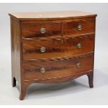 An early 19th century mahogany bowfront chest with crossbanded top and oak-lined drawers, height