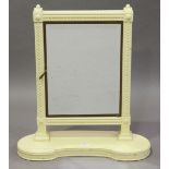 A 20th century cream painted and brass framed triptych dressing table mirror, on a kidney shaped
