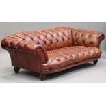 A modern Chesterfield style buttoned brown leather settee, raised on reeded hardwood legs, height