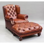 A modern buttoned brown leather wingback armchair, on reeded hardwood legs, height 96cm, width 84cm,