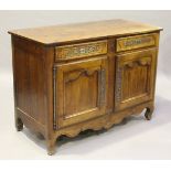 An early 20th century French fruitwood side cabinet, fitted with drawers above cupboards, on