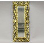 A 19th century Florentine giltwood and gesso framed wall mirror, decorated with foliate scrolls,