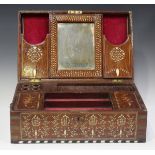 A late 19th century Indian hardwood and bone inlaid dressing box, the hinged lid enclosing a