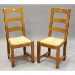A set of six 20th century French oak ladder back dining chairs with rush seats, height 105cm,