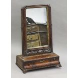 A George II mahogany swing frame mirror, the base fitted with three drawers, height 65cm, width 45cm