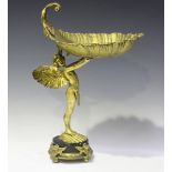 A late 20th century gilt metal and black marble tazza in the form of a cupid holding a large leaf-
