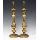 A pair of modern gilded and turned wooden table lamps, height 63cm.Buyer’s Premium 29.4% (