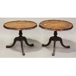 A pair of 20th century Edwardian style satinwood occasional tables, the shaped tops inlaid with