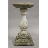 A 20th century cast composition stone garden bird bath, raised on a baluster stem and serpentine