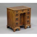 A 20th century George I style walnut crossbanded and laburnum oyster veneered kneehole desk,