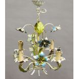A 20th century tole painted metal four-branch ceiling light with applied leaves and flowerheads,