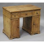 A 19th century French pine child's kneehole desk, fitted with three drawers and two cupboards,