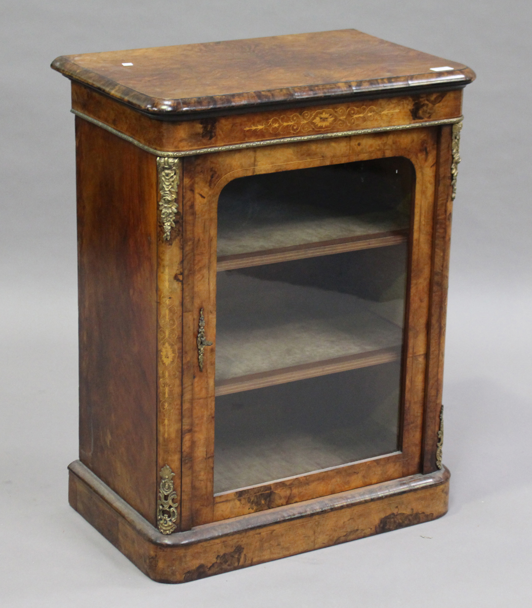 A mid-Victorian burr walnut and boxwood inlaid music cabinet with gilt metal mounts, the glazed door