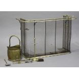 A Victorian wire mesh and brass mounted nursery fire guard, fitted with safety rail and tool
