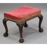 An early 20th century George II style stained walnut stool, the overstuffed seat upholstered in pale