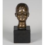 An early 20th century brown patinated cast bronze portrait bust of a young boy, cast by William