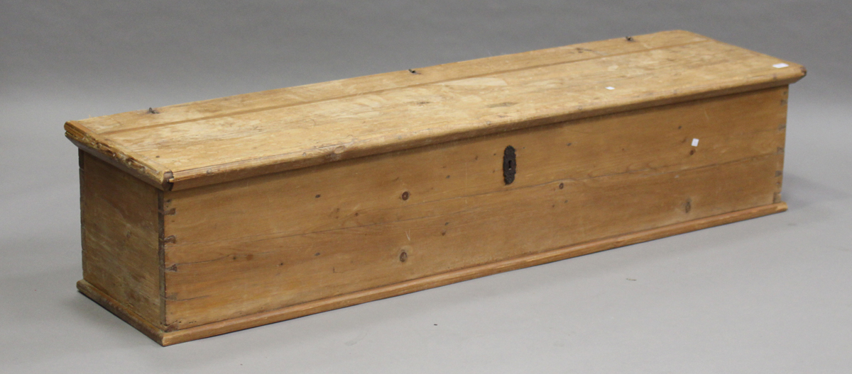 A late 19th century long pine trunk, the hinged lid enclosing a compartmentalized interior, height