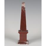 A 20th century rouge marble obelisk desk weight, height 30.5cm.Buyer’s Premium 29.4% (including