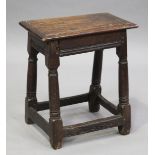 A late 17th century oak joint stool, the later top on turned and block legs, height 46cm, width