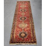 A Heriz runner, North-west Persia, mid-20th century, the red field with a column of hooked