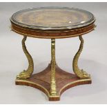 A 20th century marquetry inlaid and brass mounted centre table, the circular top raised on four