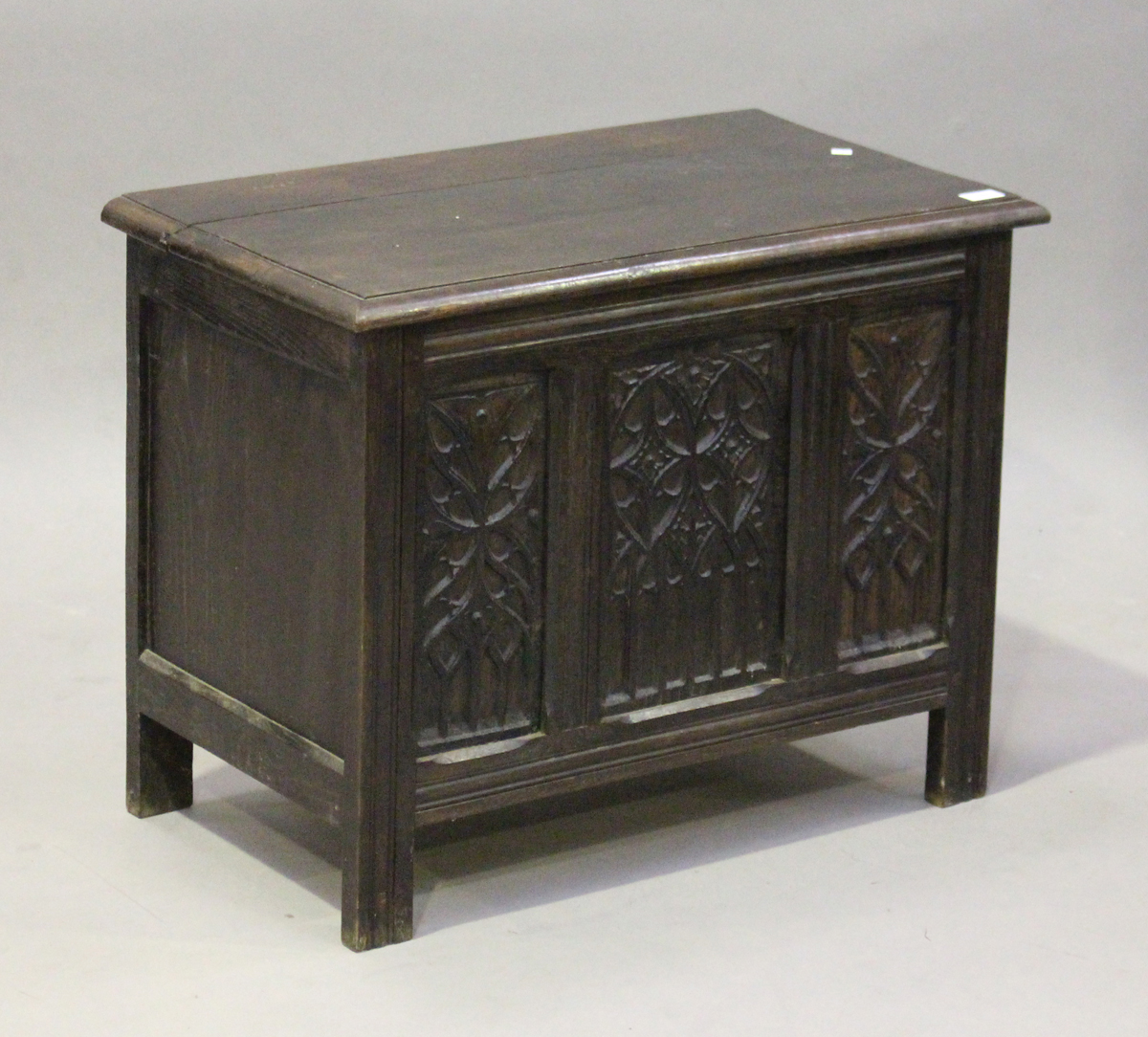 A 20th century Gothic Revival oak coffer, the front inset with three tracery panels, height 58cm,