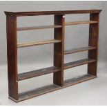 A late Victorian oak open hanging bookcase, fitted with adjustable shelves, height 134cm, width