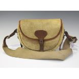 An early 20th century animal hide and brown leather satchel, the front strap tooled 'G.S.L.W.',