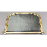 An early Victorian gilt overmantel mirror, the arched frame raised on white ceramic feet, 70cm x