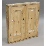A 19th century pine shallow wall cabinet, fitted with two panelled doors, height 74cm, width 67cm,