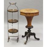 A late Victorian burr walnut octagonal work table, the hinged lid and trumpet stem on carved