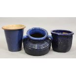 A group of three modern blue glazed earthenware garden pots, heights 42cm, 40cm and 34cm.Buyer’s