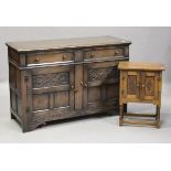 A mid-20th century Jacobean Revival oak sideboard, the two panelled doors carved with scrolls,