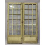 A pair of early 20th century khaki green painted, glazed and panelled French doors, each door