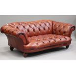 A modern Chesterfield style buttoned brown leather settee, raised on reeded hardwood legs, height