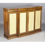 A Regency rosewood side cabinet with brass line inlay and crossbanded borders, the four doors