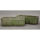 A pair of 20th century cast composition stone rectangular garden troughs, the sides decorated with