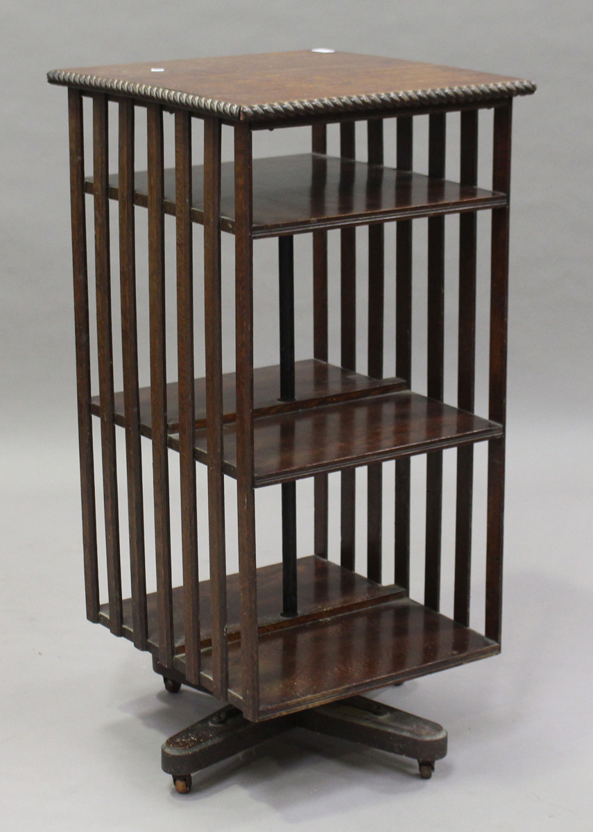 A George V oak revolving bookcase with a gadrooned edge and slatted sides, height 106cm, width