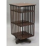 A George V oak revolving bookcase with a gadrooned edge and slatted sides, height 106cm, width