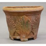 A late 20th century terracotta demi-lune garden planter, moulded with acanthus leaves, height