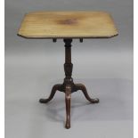 A George III mahogany square tip-top wine table with canted corners, on a turned baluster column and