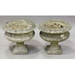 A pair of 20th century cast composition stone garden urns of squat campana form, height 38cm,