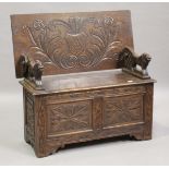 A George V oak monk's bench, the hinged top on lion supports above a box seat, height 104cm, width