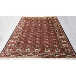 A large Turkestan style carpet, mid/late 20th century, the dark plum field with overall columns of