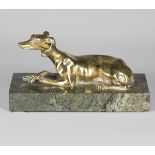 A late 19th century polished cast bronze model of a recumbent greyhound, mounted on a green marble