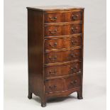 An early/mid-20th century reproduction mahogany serpentine fronted chest of six oak-lined drawers,