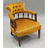 A late Victorian walnut tub back showframe armchair, upholstered in buttoned golden velour, on