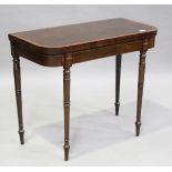 A William IV mahogany fold-over card table with satinwood crossbanding and carved details to frieze,