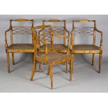 A set of four George III Sheraton period fruitwood elbow chairs, the finely carved trellis backs