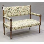 A late Victorian walnut framed salon or hall settee with carved rosette frame and fluted supports,